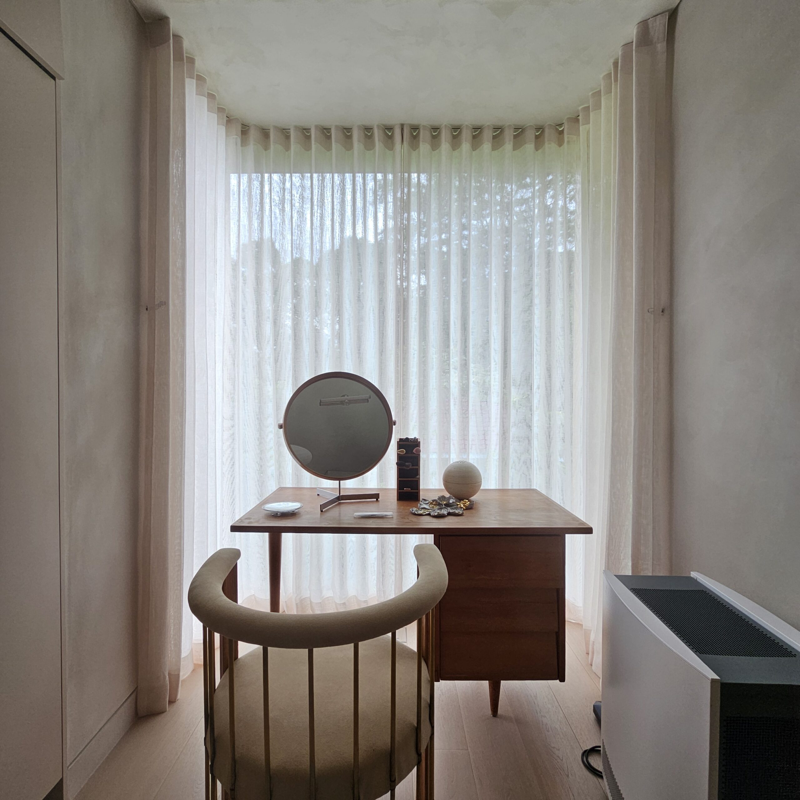 Ripple fold sheer day curtains softly filtering daylight behind a dressing table