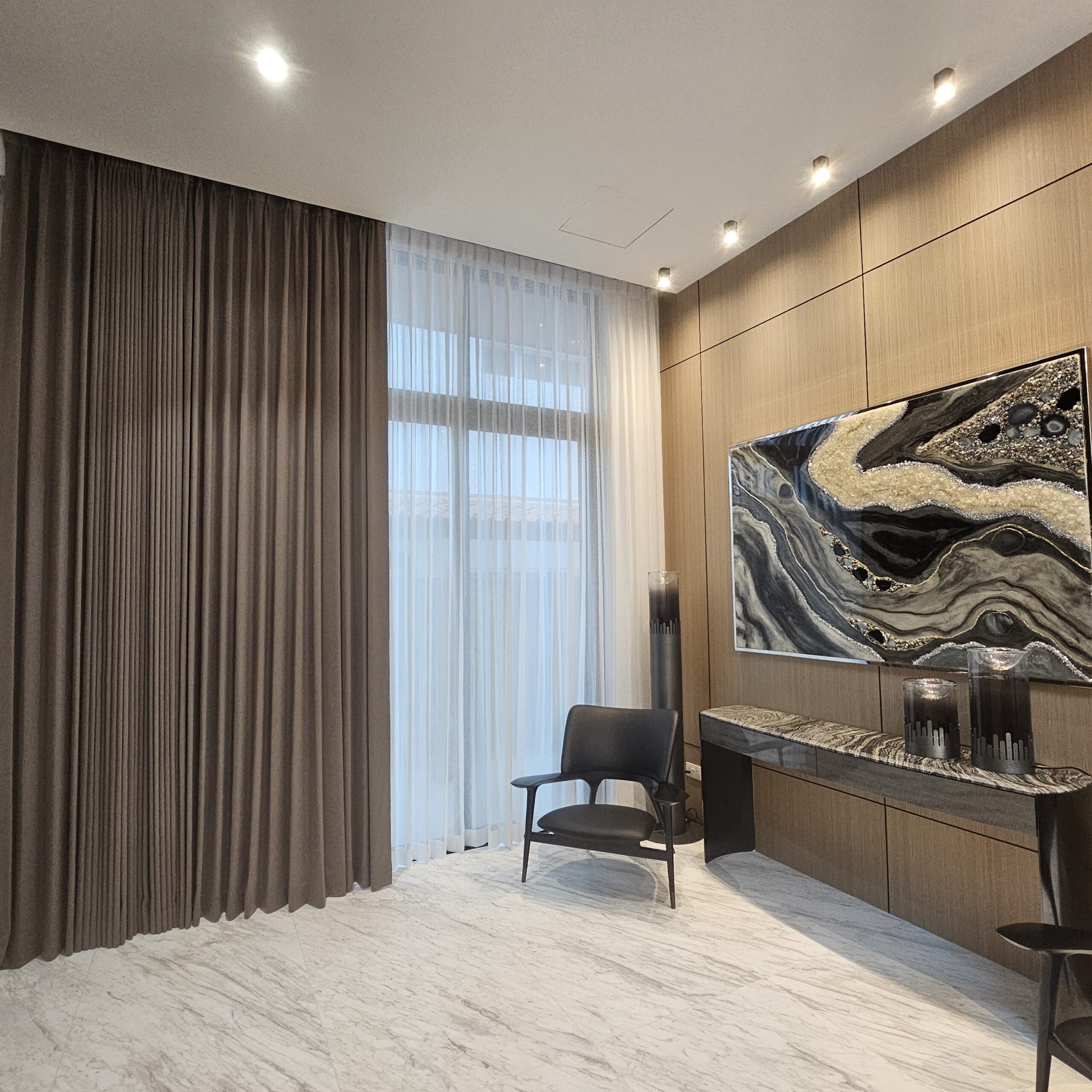 Shaped night curtains paired with sheer day curtains beside a feature wall