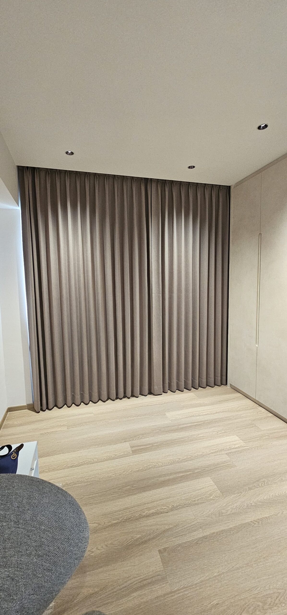 Closed full-height double pleat curtains with neat and consistent shaped folds