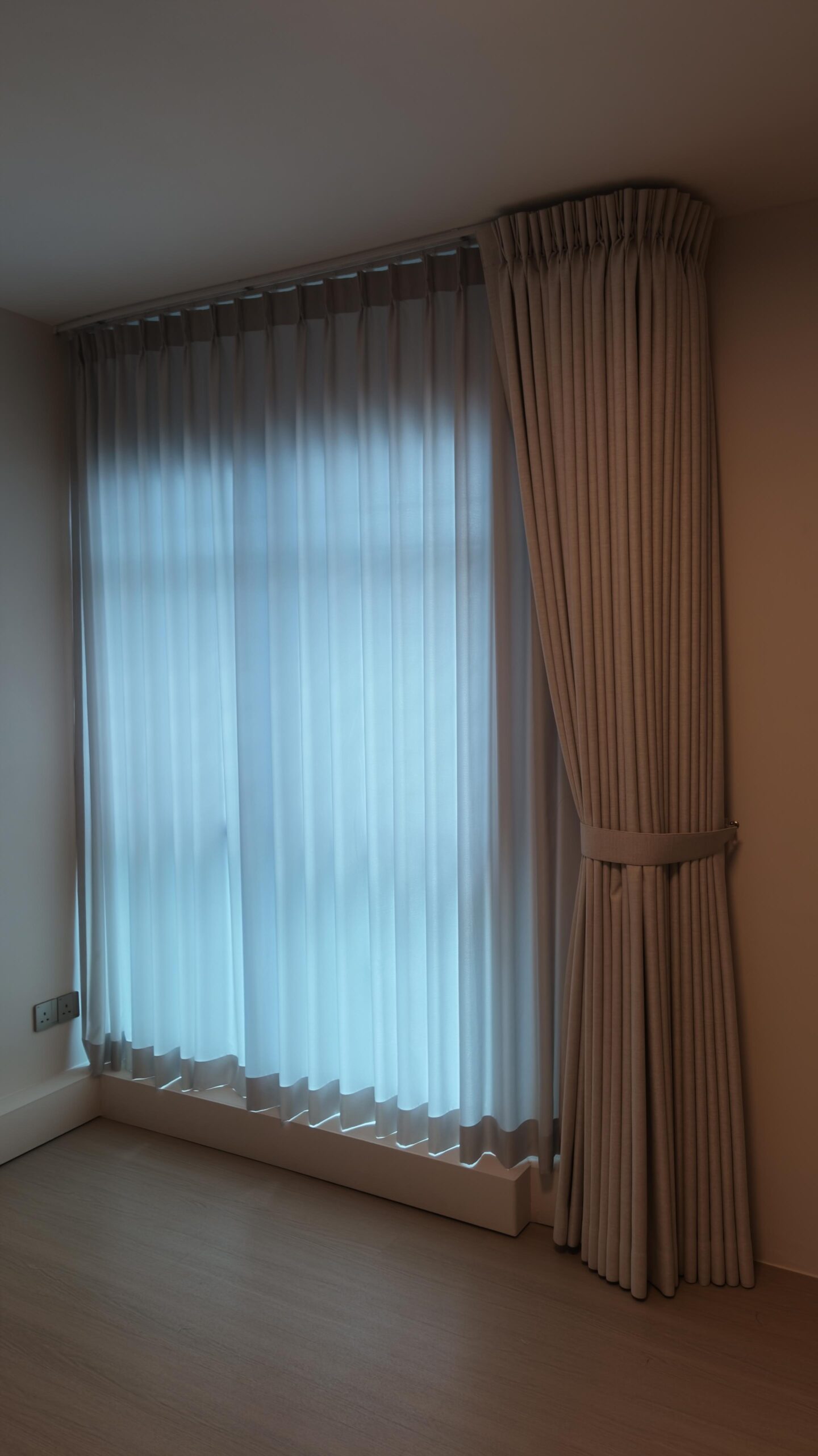 Shaped night curtain paired with full-height sheer day curtains