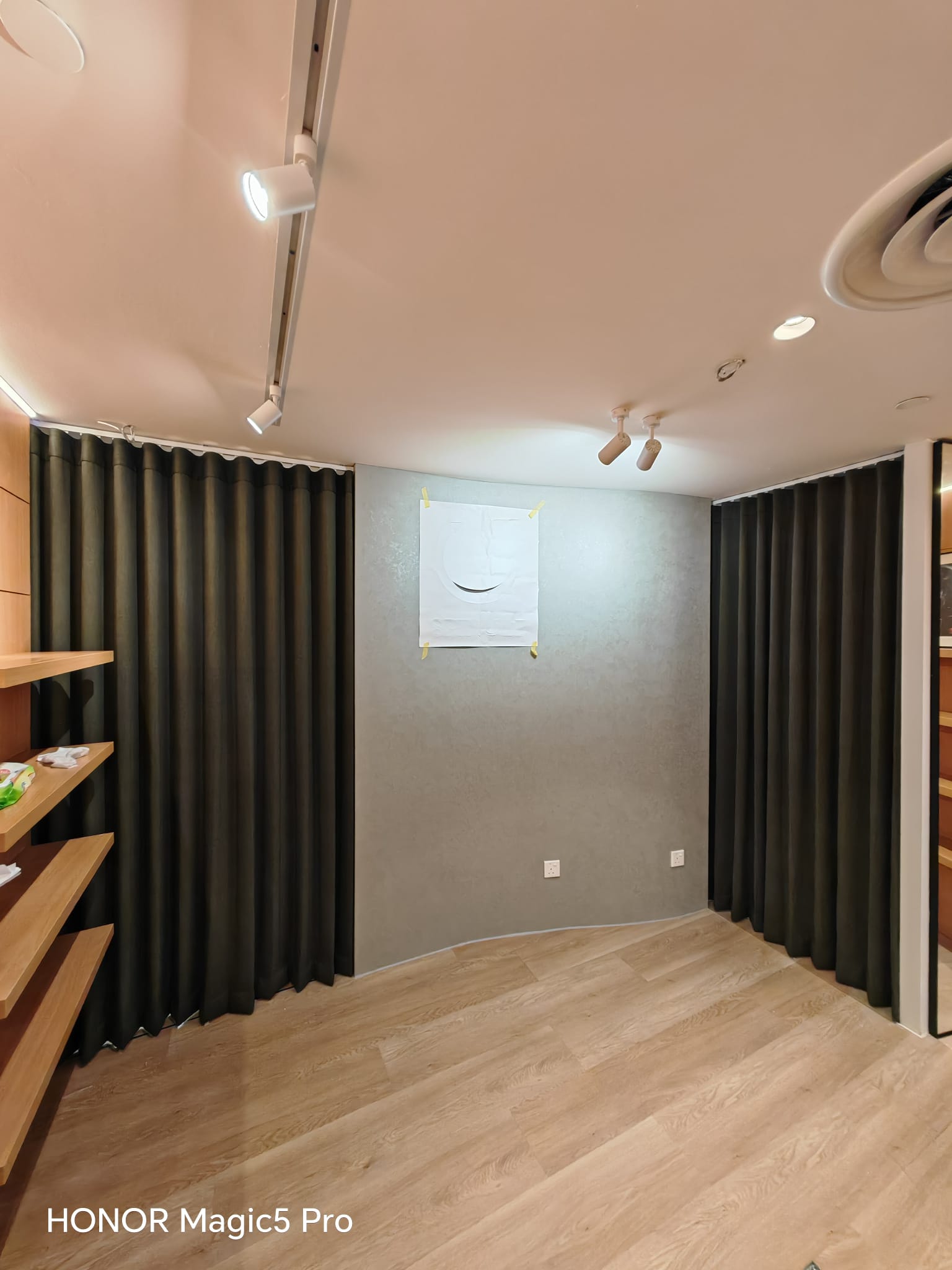 Full-height ripple fold curtains with smooth continuous waves across two openings in a boutique