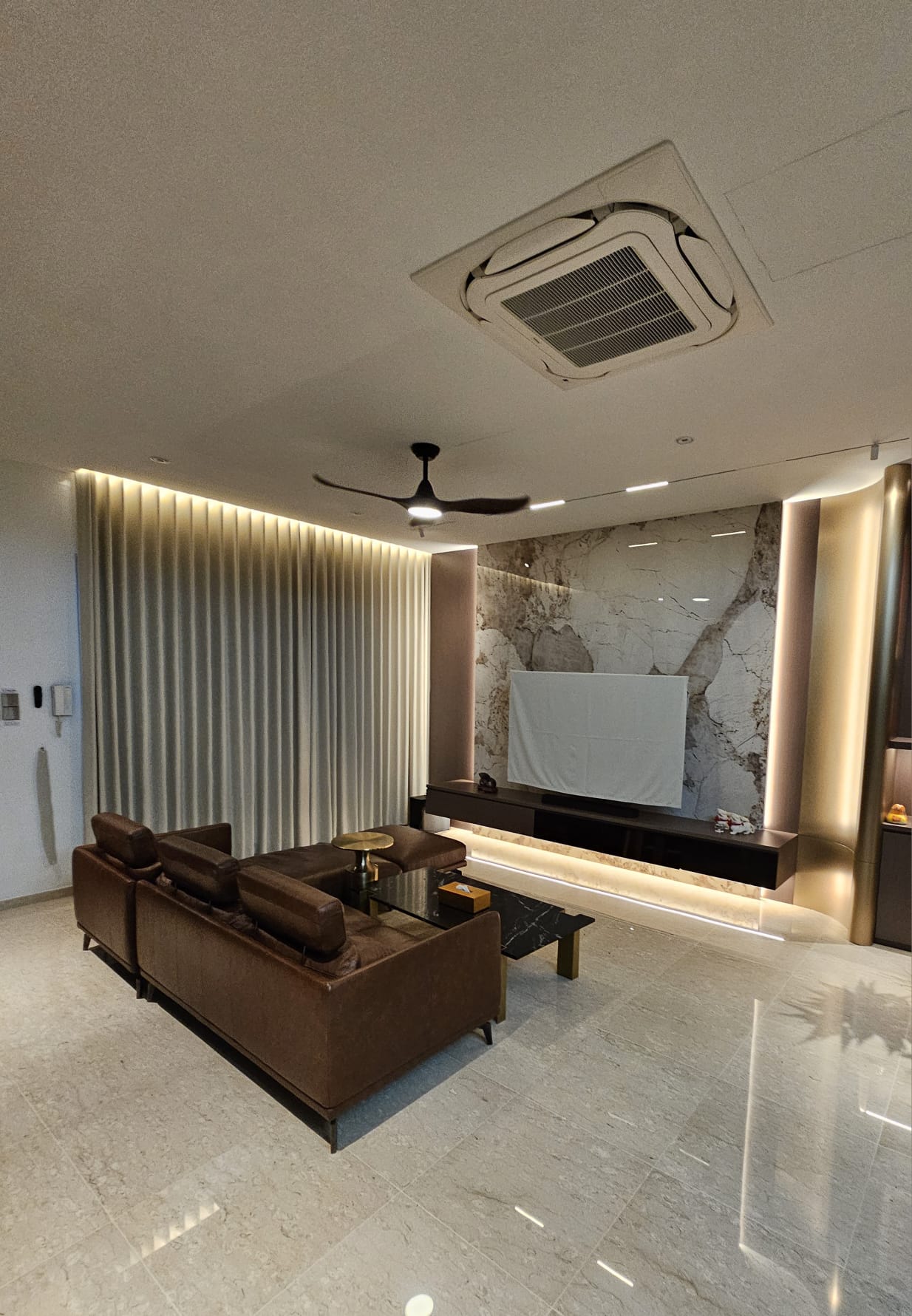 Full-height shaped Ripple Fold curtains installed across living room window
