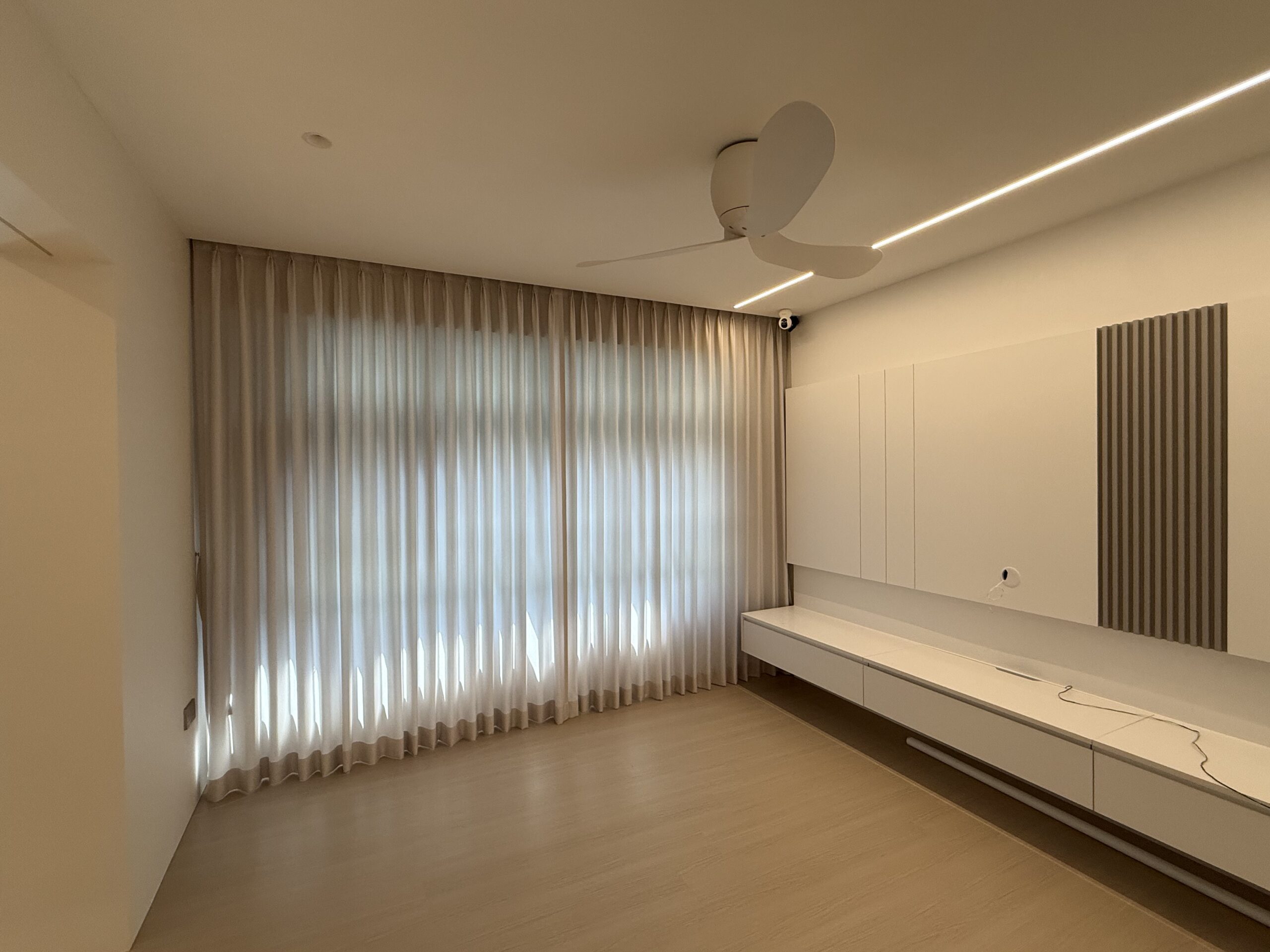 Full-height shaped privacy sheer day curtains across a wide living room window